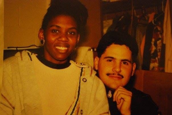 A young Juan with a mustache, smiling next to a smiling woman