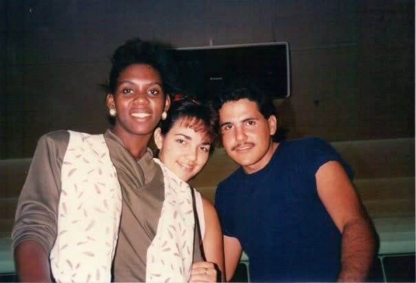 A young Juan posing with two women